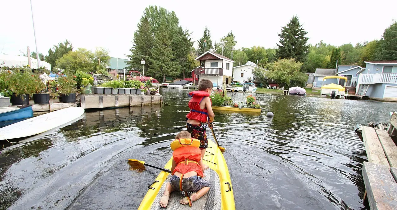 Kids on a paddle board in the lakeside channel, 2016